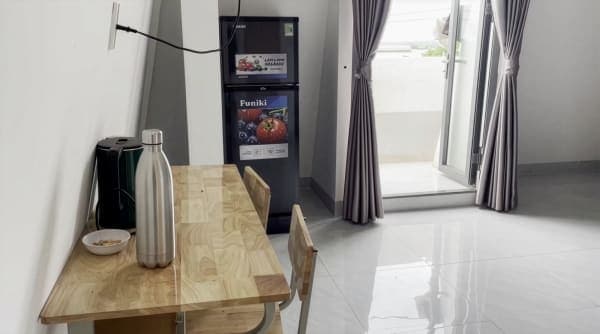 In-room fridge and dining table — BMTU hostel